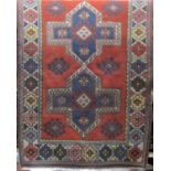 A Turkish rug with central pale medallion upon an orange ground, 200 x 130 cm
