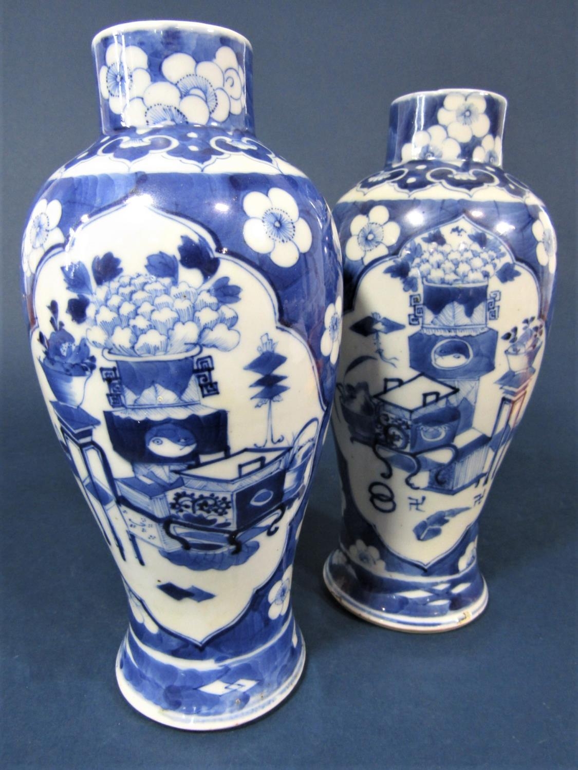 A pair of 19th century Chinese blue and white vases of shouldered form with reserved painted