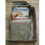 A box containing a collection of mixed 45rpm records various dates and genres (1)