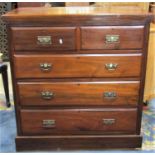 An Edwardian walnut bedroom chest of two short over three long graduated drawers with cast handles