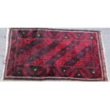 Full pile Balouchi rug with unusual fluted decoration upon a deep red ground, 145 x 75 cm