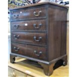 A small Georgian style mahogany chest of four long graduated drawers with crossbanded detail