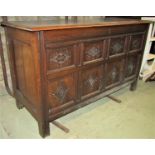 An antique oak coffer with hinged lid, moulded panelled frame, the front elevation with lozenge