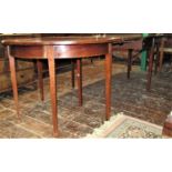 A Georgian mahogany D end extending dining table crossbanded in satinwood comprising a pair of D end