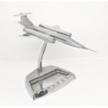 Trench Art Interest - A chrome desktop model of a stylised jet, 10cm wingspan