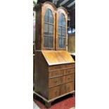 A good quality Queen Anne style walnut veneered bureau bookcase with inlaid chevron banding, the