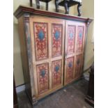 An unusual pine storage cupboard, the front elevation enclosed by two quarter panelled doors, set