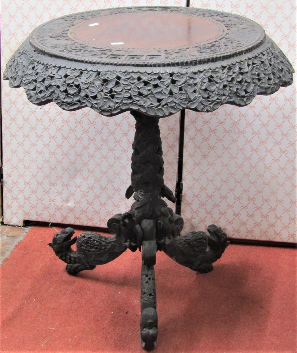 A 19th century Indonesian hardwood occasional table with circular top and carved and pierced