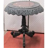 A 19th century Indonesian hardwood occasional table with circular top and carved and pierced