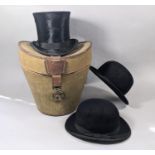 An Edwardian green canvas and leather travelling hat box containing a Christy's of London top hat