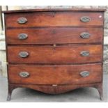 A Regency mahogany bow front bedroom chest of four long graduated drawers with oval embossed brass