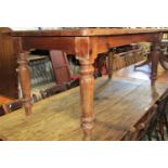 A Victorian style pine farmhouse kitchen table, the rectangular top with moulded outline and rounded