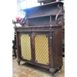 A Regency rosewood chiffonier, enclosed by a pair of panelled doors with brass insets, flanked by