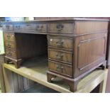 A reproduction Georgian style mahogany veneered kneehole twin pedestal desk, the rectangular top