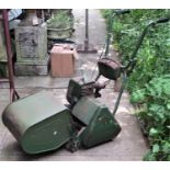 A vintage Atco Petrol Driven Cylinder Lawn Mower, with rear roller, 36cm cut, complete with grass