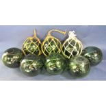 A collection of eight various antique green glass buoys, 12 cm diameter (12)