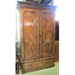 A Victorian mahogany wardrobe with stepped and moulded cornice over a pair of three quarter length