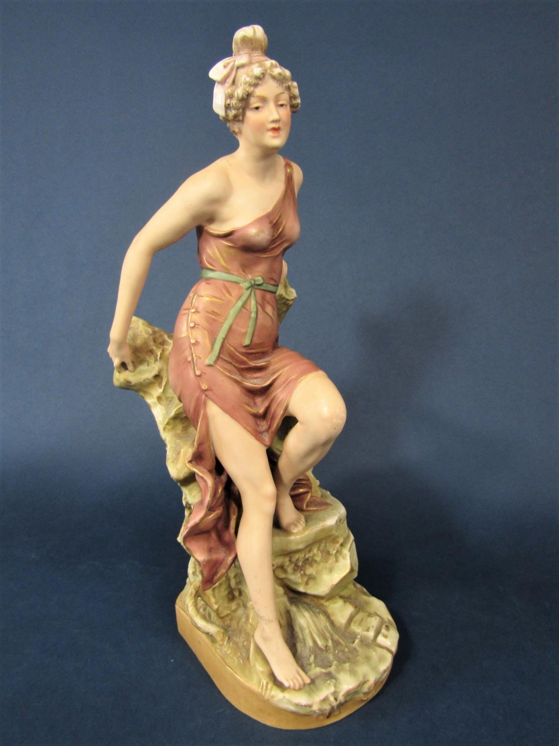 Early 20th century Royal Dux figure of a classical style female character perched on a rock, with