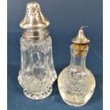 Cut glass silver topped bitters dispenser together with a further silver topped cut glass sugar