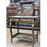 An Edwardian rosewood bonheur de jour, with serpentine outline and raised on shaped supports, with