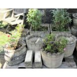 Two pairs of reclaimed garden planters, one of square tapered form with oval relief panels, the