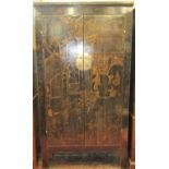 A Chinese Qing black lacquered hanging cupboard with gilded chinoiserie detail, the interior