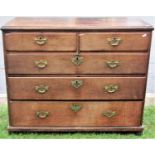 A Georgian oak bedroom chest of two short over three long graduated drawers raised on squat later