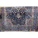 Old Persian Keshan type carpet with central floral medallion upon a navy blue ground, 340 x 240