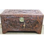 An Eastern camphor wood box/chest with profusely carved detail and engraved brass lock plate,