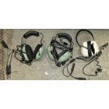 Three Aviation headsets comprising two David Clark examples, with light green ear pieces, model