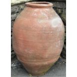 A weathered terracotta oviform jar, 64cm high