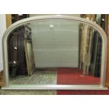 A contemporary Victorian style overmantle mirror with moulded arched and silver painted frame, 125