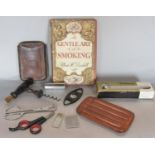 A collection of smoking related effects including two leather cigar pouches, cutters, etc, 19th