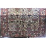 Good large Persian carpet decorated with various still life's and scrolled foliage upon a fawn