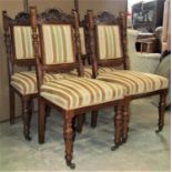 A set of four good quality late Victorian/Edwardian oak framed dining chairs with carved shell,