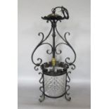 An arts and crafts gothic style hall lantern with wrought iron frame and moulded cylindrical glass