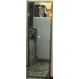 An Art Deco style full length dressing mirror of rectangular form with simple mitred brass frame,