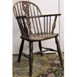 A Georgian period comb back Windsor elbow chair, principally in elm and ash, with pierced splat