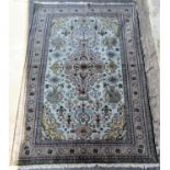 Good quality Kazak rug with central pastel medallion framed by still life icons upon a mint green