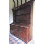 A good quality 18th century style oak dresser, the lower section enclosed by three fielded panel