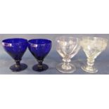 Pair of antique blue glass rummers together with two further antique glass rummers, one acid