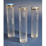 Three faceted glass silver topped dressing set bottles, one in guilloche enamel (3)