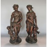 A pair of 19th century spelter figures females and children carrying wheatears and grapes, 40 cm