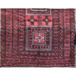 Good old Balouchi carpet, with typical central block medallions upon a washed red ground, 255 x