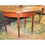 A simple Georgian mahogany three sectional drop leaf dining table, the two D ends adjoining a drop