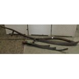 An antique agricultural scythe with stained ash wood handle and cast iron fitting stamped