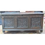 An early 18th century oak coffer, the front elevation enclosed by three panels with repeating