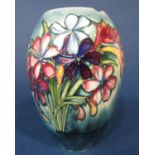 A Moorcroft blue ground vase with painted freesia decoration with painted signature to base (af)