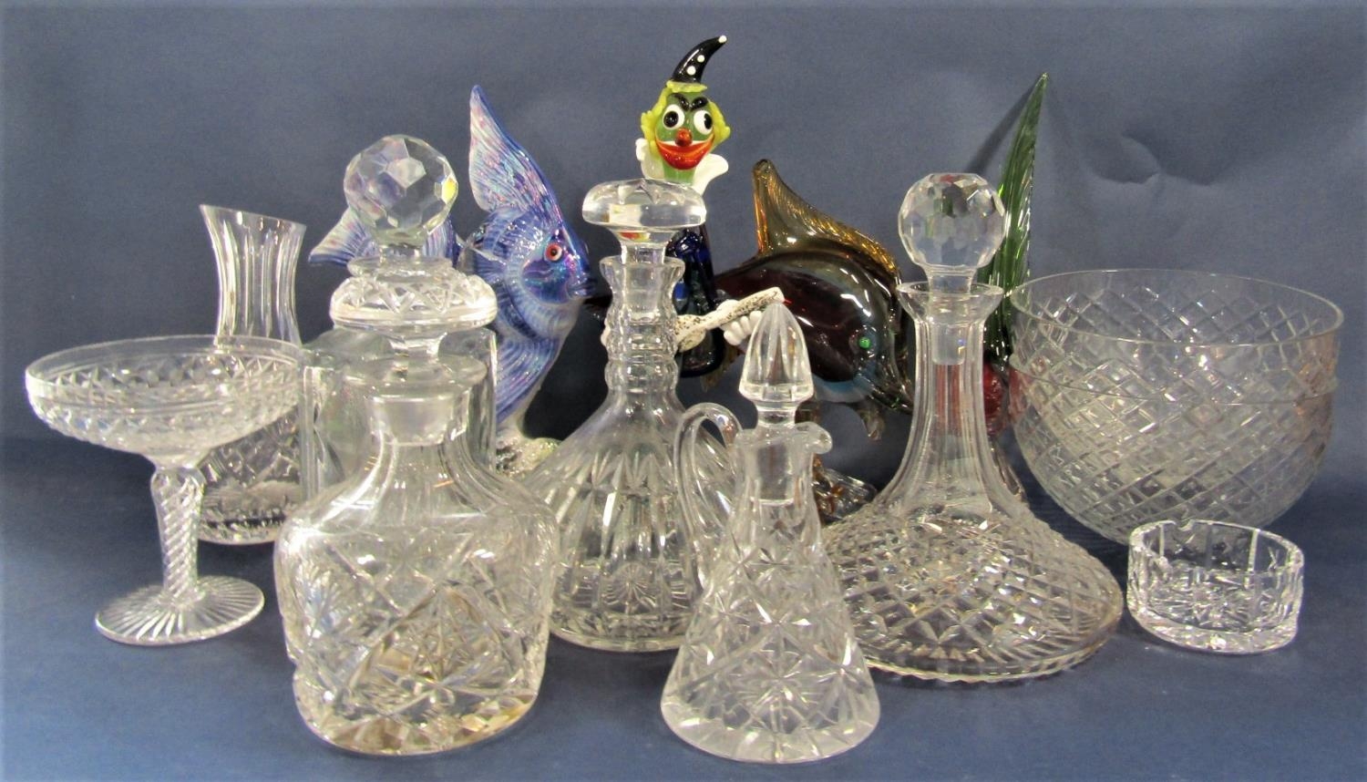 A collection of glassware to include decanters, jugs, bowls, a Murano glass clown, fish and