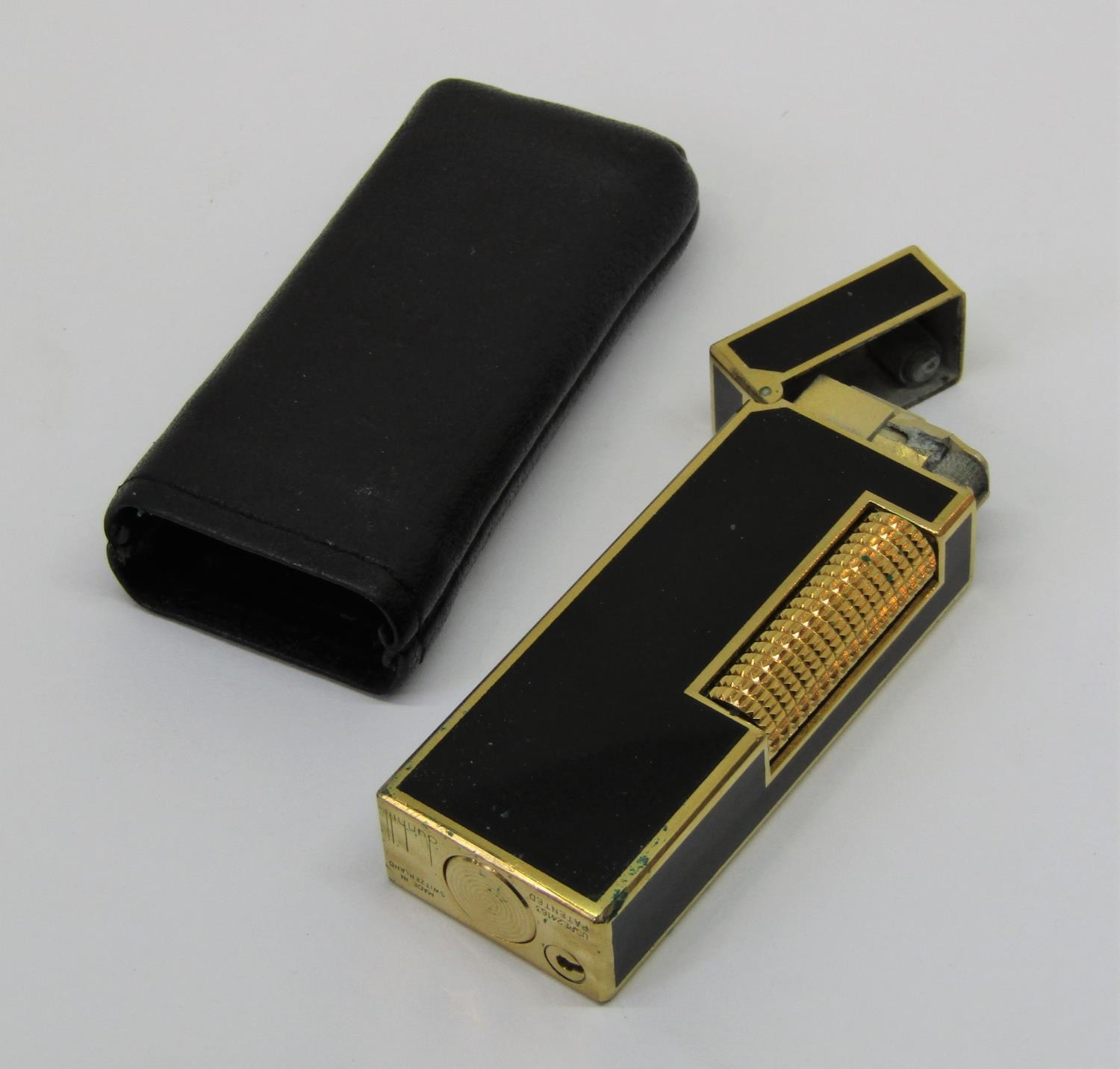 Dunhill enamel and gold plated lighter, patented US. RE24163, within a leather pouch, 6.5 cm high
